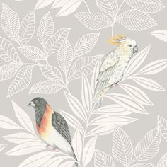 two birds sitting on top of a green leafy wallpaper covered in white leaves