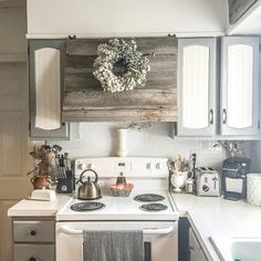 a white stove top oven sitting inside of a kitchen