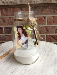 a glass jar filled with sand and a key