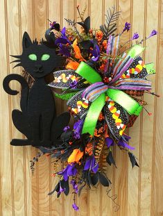 a halloween wreath with a black cat on it