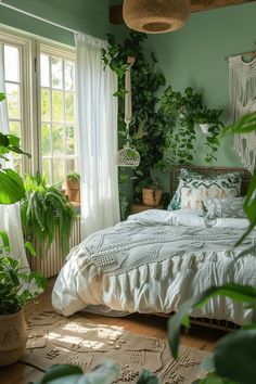 a bedroom with green walls and plants on the windowsill, bed in foreground