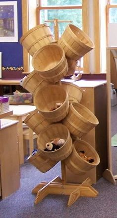 a stack of wooden buckets sitting on top of a table