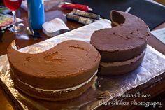 two chocolate cakes sitting on top of aluminum foil