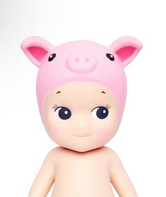 a pink pig toy sitting on top of a white surface with eyes wide open and one eye half closed