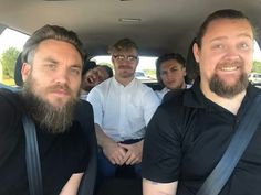 a group of people sitting in the back of a car with one person taking a selfie