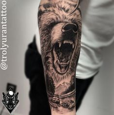 a man with a bear tattoo on his arm