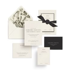 the wedding stationery is laid out on top of each other, with black and white accents