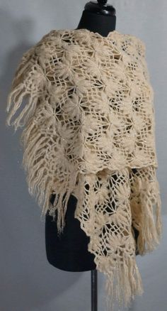 a white shawl on a mannequin with lace and crochet work