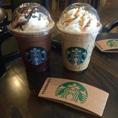 two starbucks drinks with whipped cream and chocolate