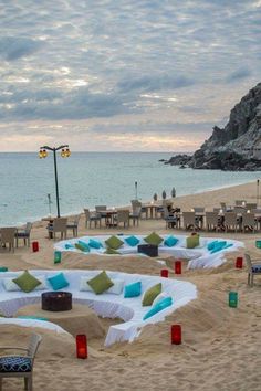 tables and chairs are set up on the beach