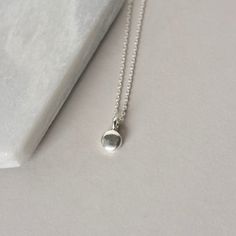 A dainty minimalist accessory that's perfect for everyday wear! This necklace features a tiny sterling silver pebble charm paired with sterling silver cable chain. The small disc is 5mm wide and about 2mm thick and it has a sleek bright polish that gives the necklace a modern feel. The simple design makes this a versatile accessory and it looks chic alone or layered with others. The necklace is fastened with a sterling silver spring ring clasp and you can choose your desired length from the drop Simple Adjustable Charm Necklace For Everyday, Everyday Sterling Silver Charm Necklace With Moon Charm, Sterling Silver Moon Charm Necklace For Everyday, Adjustable Tiny Charm Necklaces For Everyday, Dainty Silver Charm Necklaces For Everyday, Simple Sterling Silver Charm Necklace For Everyday, Minimalist Tiny Charm Necklaces For Everyday, Simple Round Pendant Charm Necklace For Everyday, Simple Everyday Sterling Silver Charm Necklace