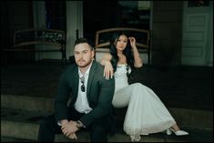 a man and woman sitting on steps next to each other