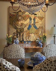 a dining room table with blue and white chairs