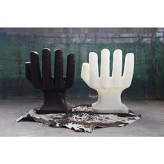 two black and white hand sculptures sitting next to each other