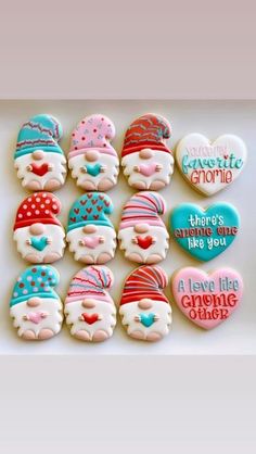 three decorated cookies with frosting and decorations on top of a white table next to a striped background