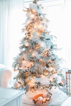 a white christmas tree in the corner of a room