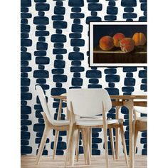 a dining room with blue and white wallpaper that has geometric shapes on the walls