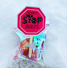 a red stop sign sitting on top of a bag filled with assorted candies