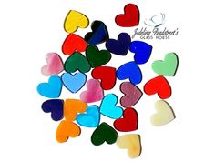 multicolored heart shaped glass magnets on a white background