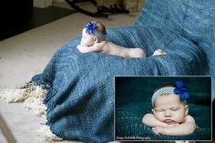 a baby wrapped in a blanket with a blue bow laying on it's side