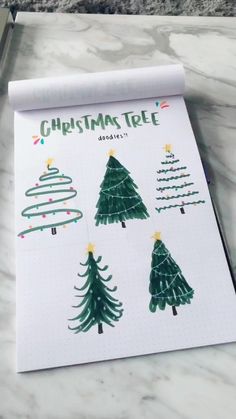 the christmas tree stickers are on top of a sheet of white paper with green trees