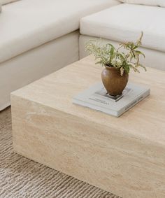 a wooden coffee table with a vase on top