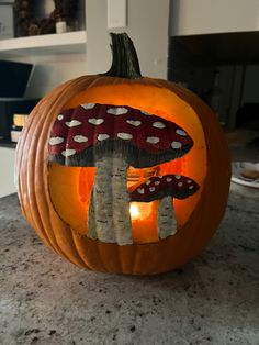 a pumpkin with mushrooms painted on it