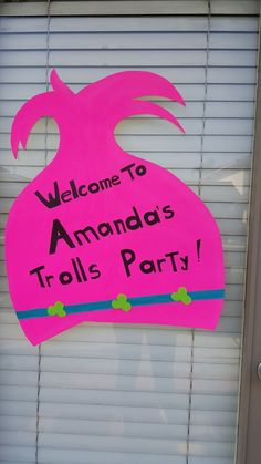 a pink sign that says welcome to amanda's trolls party on the door