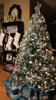 a christmas tree with blue and silver ornaments