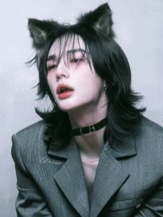 a woman with black hair and cat ears on her head, wearing a gray suit