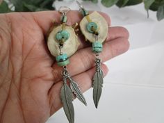 Turquoise and Deer Antler Dangle Earrings. Beautiful and quite different antler and turquoise earrings. Yes, actual deer antlers, made of naturally-shed antler bone, carved and polished smooth. No deer were harmed! These have a 3 1/4" drop from their sterling silver French wires, easy and secure on/off. Genuine turquoise heishi with silver feathers flowing from each earring. Gorgeous rustic earrings, and can be for either women or men. The wires are stamped 925. Nature-inspired Turquoise Dangle Earrings, Turquoise Nature-inspired Drop Earrings, Dear Antler, Deer Horn Jewelry, Dear Antlers, Deer Antler Jewelry, Antler Earrings, Feather Earrings Silver, Antler Jewelry