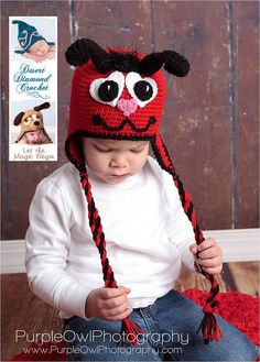 a small child wearing a red and black hat