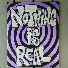 a purple and black painting with the words nothing is real