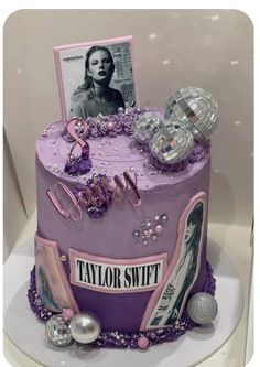 a birthday cake with an image of taylor swift on top and decorations around the edges