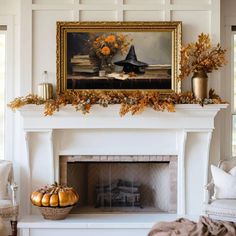 a white fireplace with a painting on the mantle and pumpkins in front of it