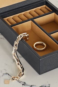 Smythson's 'Panama' jewelry box has been beautifully handcrafted in Spain from the label's textured-leather that's stamped with the logo in gold lettering. It opens to a soft nubuck interior with three compartments and seven ring slots to keep your collection free from secure and organized. Leather Organization, Leather Jewelry Box, Paper Tray, Jewelry Roll, Gold Lettering, Leather Box, Wallets For Women Leather, Black Textures, Leather Jewelry