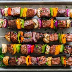 skewered steaks and vegetables on a tray