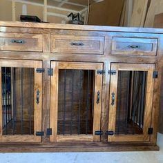 a wooden cabinet with glass doors and metal bars on the front door, in a room