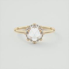 an oval shaped white diamond ring with two yellow gold band