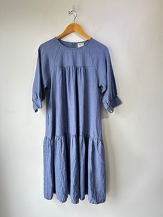 Beaton Cornflower Blue Linen Dress. The prettiest color! Perfectly flowy with tiered pleats to add some texture and volume. Button closure short sleeves and big pockets. Machine wash cold and line dry, marked size Sm. Approximate measurements:Underarm to underarm: 18"Length: 40" Short Sleeve Midi Dress With Pleated Hem, Blue Pleated Short Sleeve Midi Dress, Blue Pleated Midi Dress With Short Sleeves, Blue Flowy Midi Length Tiered Dress, Spring Tiered Dress With Pockets, Blue Casual Flowy Tiered Dress, Casual Blue Flowy Tiered Dress, Relaxed Fit Short Sleeve Dresses With Ruffle Hem, Blue Short Sleeve Pleated Maxi Dress