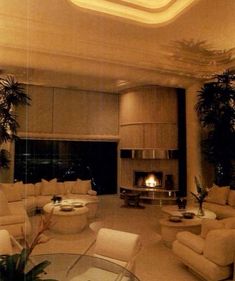 a living room filled with furniture and a fire place in the middle of it's walls