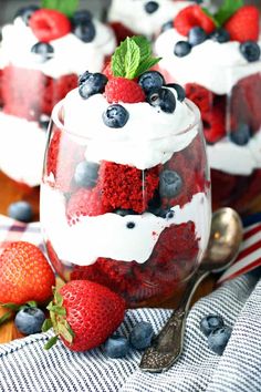 red velvet berry parfaits in a glass jar with strawberries and blueberries