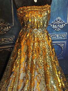 "Very Beautiful and shiny sequined lace. Premium quality. Orange gold and silver. Width 53\". Price for 1 yard." Gold Sequin Dress With Contrast Detail For Wedding, Gold Sequin Dress For Prom And Festive Occasions, Festive Gold Sequin Dress For Gala, Glamorous Gold Sequin Fabric For Prom, Glamorous Contrast Sequin Fabric For Wedding, Gold Sparkling Sequin Dress For Evening, Gold Sparkling Sequin Prom Dress, Gold Sparkling Sequin Dress For Wedding, Gold Embellished Sequin Dress For Party Season