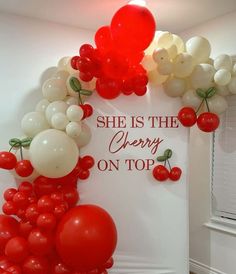 the balloon arch is decorated with red and white balloons