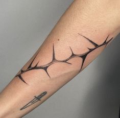 a man's arm with an arrow tattoo on it