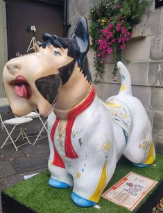 a statue of a dog with its tongue out