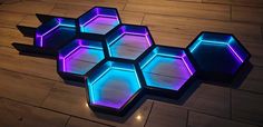 several hexagonal lights are on the floor in front of a wooden flooring