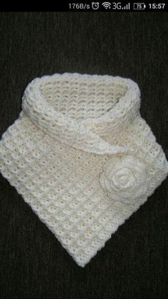 a white crocheted scarf with a flower on it