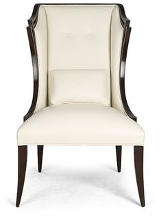 an upholstered white chair with dark wood trimmings and nail polishing