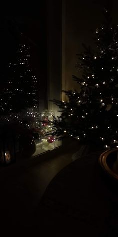 a christmas tree is lit up in the dark